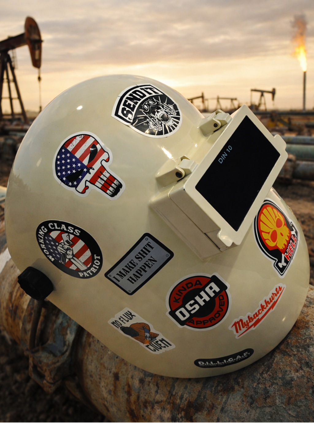 White helmet with various stickers in an industrial setting